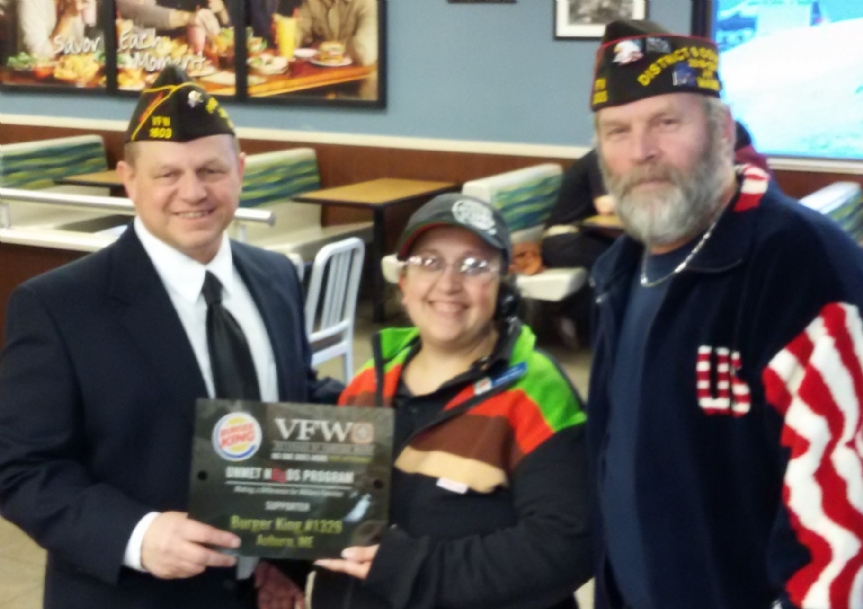 Post Commander Howard Gooldrup presents a plaque to Heather Thibodeau from Burger King with assistance of District 9 Commander Craig DuFour. 